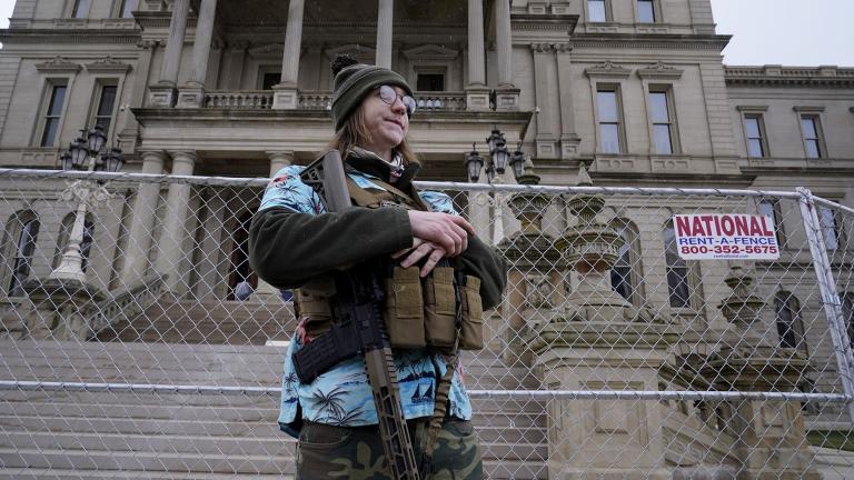 Timothy Teagan, a member of the Boogaloo Bois movement, stands with his rifle outside the state capitol in Lansing, Mich., Sunday, Jan. 17, 2021. (AP Photo / Paul Sancya)