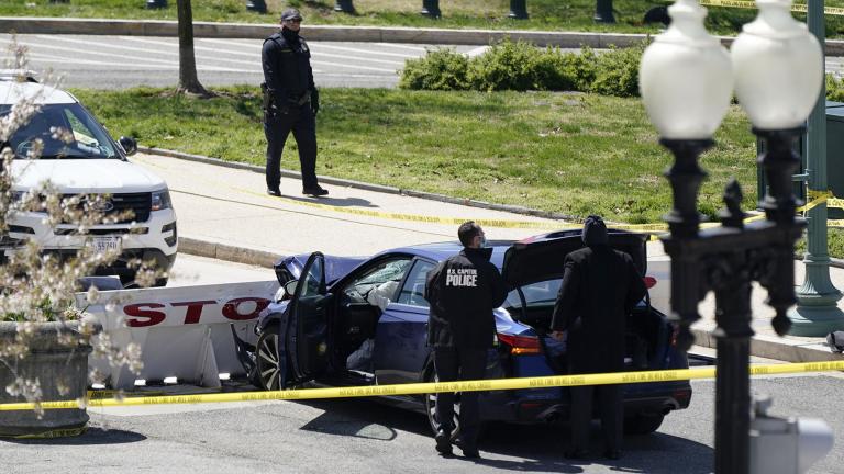 U.S. Capitol Police officers stand near a car that crashed into a barrier on Capitol Hill in Washington, Friday, April 2, 2021. (AP Photo / J. Scott Applewhite)
