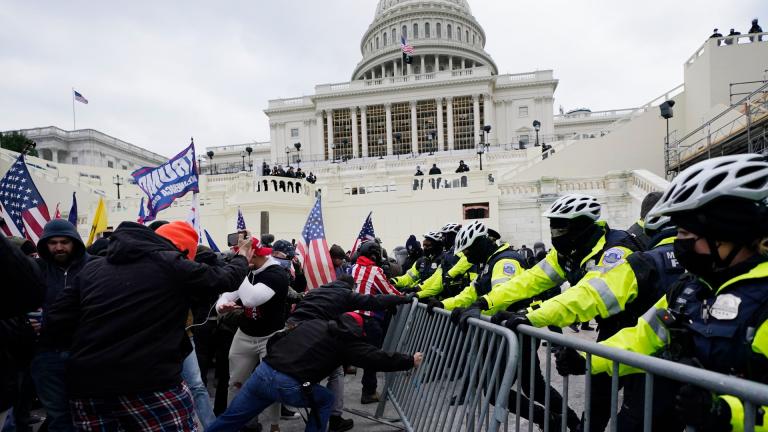 Violent insurrectionists loyal to President Donald Trump try to break through a police barrier on Jan. 6, 2021, at the Capitol in Washington. (AP Photo / Julio Cortez, File)