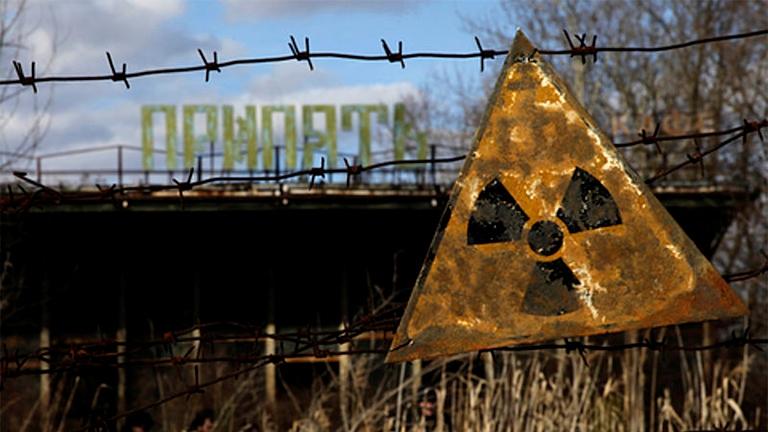 A radioactive sign hangs on barbed wire outside of a café in Pripyat, which is near the Chernobyl Power Plant. (Diana Markosian  / Wikimedia)