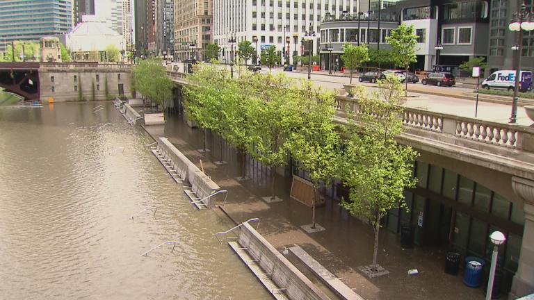A flooded Riverwalk along the Chicago River. (WTTW News)