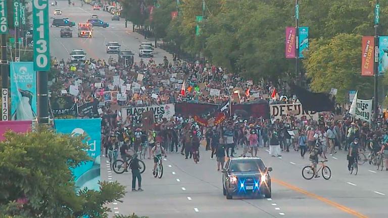Surveillance footage released by the Chicago Police Department shows protesters marching toward the Christopher Columbus statue on July 17, 2020 evening. (Chicago Police Department)