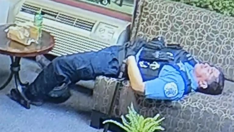 A screenshot from a video shown to the media on Thursday, June 11, 2020 shows a Chicago police officer lying down inside the office of U.S. Rep. Bobby Rush. (WTTW News via City of Chicago)