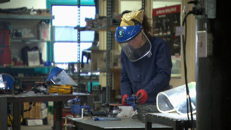A woman working at the Chicago Women in Trades training center on March 7, 2025. (WTTW News)