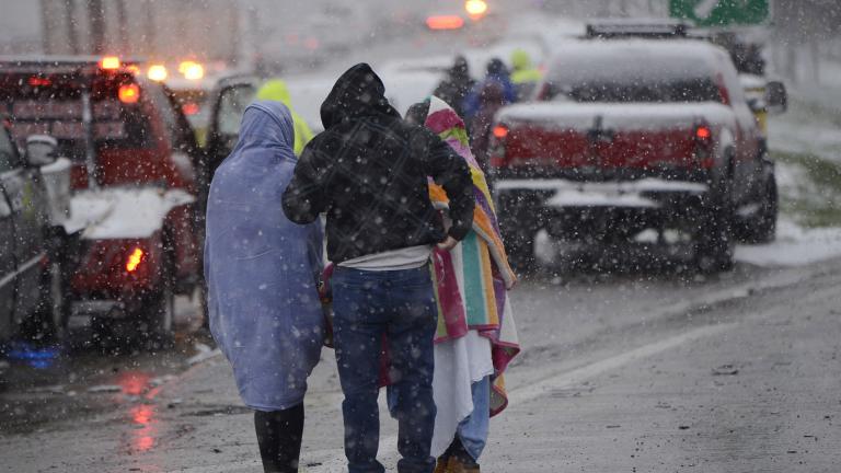 Motorists huddle together after a 54 car pile-up early morning on the Kennedy Expressway Wednesday, April 15, 2020, in Chicago. (AP Photo / Paul Beaty)
