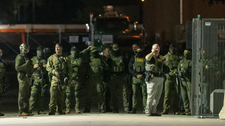 Federal law enforcement officers stand guard in the open gate of the fence built on Beach Street outside the Broadview ICE processing facility in suburban Broadview, Tuesday, Oct. 14, 2025. (Tyler Pasciak LaRiviere/Chicago Sun-Times via AP)