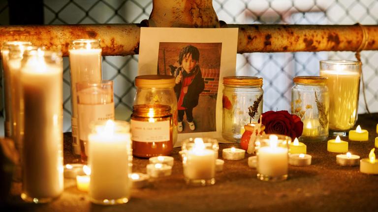 A memorial for Jean Carlos Martinez Rivero sits on the ground next to candles during a vigil for the 5-year-old who died over the weekend at the Lower West Side shelter, Wednesday, Dec. 20, 2023, in Chicago. (Armando L. Sanchez / Chicago Tribune via AP)