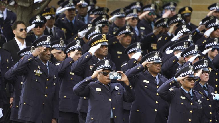Chicago police officers salute as the body of slain Chicago police Officer Ella French is carried into the St. Rita of Cascia Shrine Chapel for a funeral service Thursday, Aug. 19, 2021, in Chicago. (AP Photo / Charles Rex Arbogast)