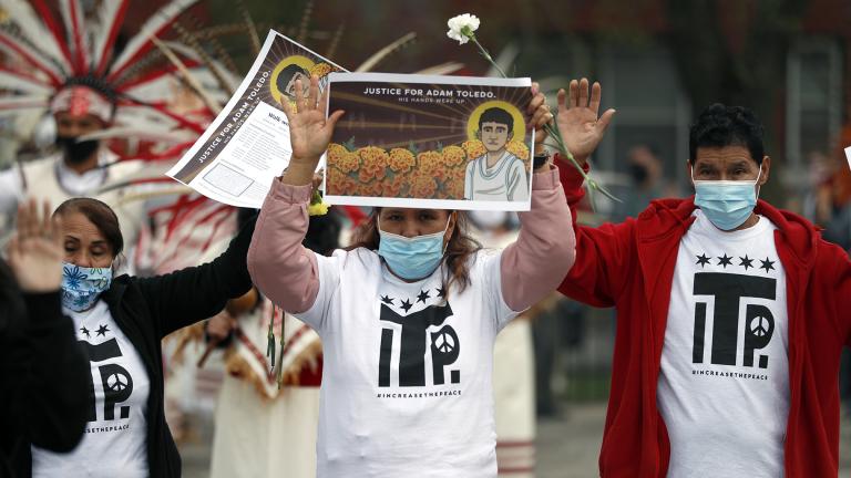 Demonstrators raise their hand as they attend a peace walk honoring the life of police shooting victim 13-year-old Adam Toledo, Sunday, April 18, 2021, in Chicago’s Little Village neighborhood. (AP Photo / Shafkat Anowar)