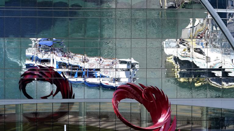 Chicago River tour boats are reflected by a building window in Chicago, Wednesday, Sept. 1, 2021. (AP Photo / Nam Y. Huh)