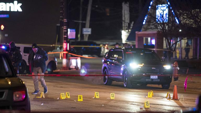 Chicago and Evanston police investigate a crime scene after a gunman went on a shooting spree before being killed by police during a shootout in Evanston on Saturday night, Jan. 9, 2021. (Ashlee Rezin Garcia / Chicago Sun-Times via AP)