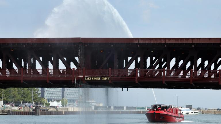 Water pumped by a Chicago Fire Department boat flows down onto the DuSable Lake Shore Drive bridge over the Chicago River on Wednesday. Sept. 2, 2026. The double-leaf, double-deck, fixed counterweight bridge became stuck earlier in the day. (Terrence Antonio James / Chicago Tribune via AP)