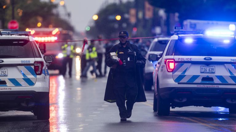 Chicago police investigate the scene of a mass shooting where more then a dozen people were shot in the Auburn Gresham neighborhood of Chicago, Tuesday, July 21, 2020. (Tyler LaRiviere / Chicago Sun-Times via AP)