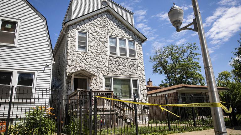 Crime scene tape hangs outside a house where multiple people were shot, some fatally, inside the Englewood building, Tuesday, June 15, 2021. (Ashlee Rezin Garcia / Chicago Sun-Times via AP)