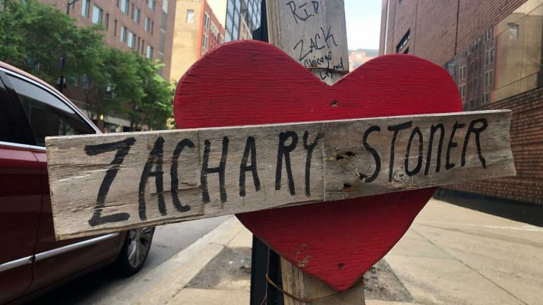 In this May 22, 2019 photo, a makeshift cross marking the spot where Zachary Stoner was killed on May 30, 2018, in a drive-by shooting in downtown Chicago. (AP Photo/Michael Tarm)