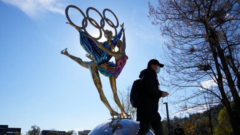 A visitor to the Shougang Park walks past a sculpture for the Beijing Winter Olympics in Beijing, China, Tuesday, Nov. 9, 2021. (AP Photo / Ng Han Guan)