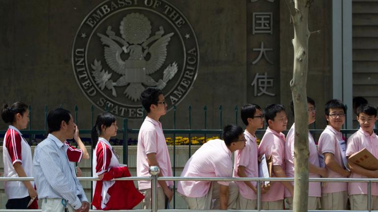 Chinese students wait outside the U.S. Embassy for their visa application interviews, in Beijing on May 2, 2012. (AP Photo / Alexander F. Yuan, File)