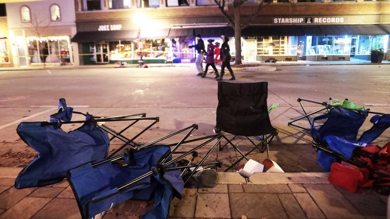 Toppled chairs line W. Main St. in downtown Waukesha, Wis., after an SUV drove into a parade of Christmas marchers Sunday, Nov. 21, 2021. (John Hart/Wisconsin State Journal via AP)