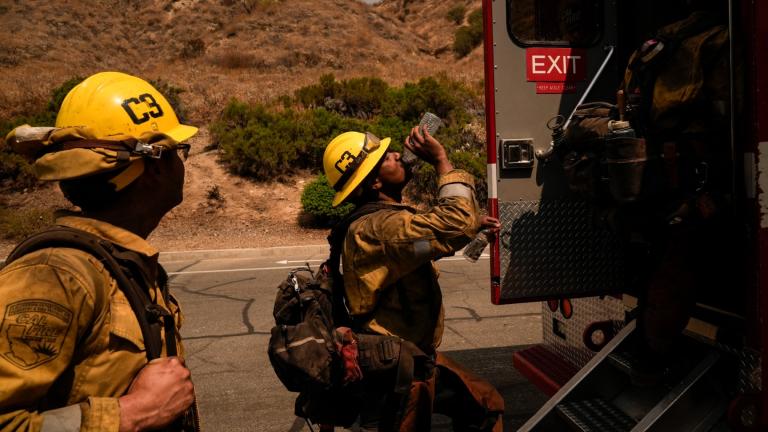 Firefighter Geo Mulongo, center, finishes his water while taking a break during the Line Fire in Highland, Calif., Sept. 6, 2024. (AP Photo / Jae C. Hong, File)