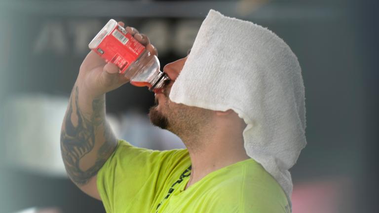 A construction worker hydrates at the Shedd Aquarium, Aug. 27, 2024, on a hot day in Chicago. (AP Photo / Charles Rex Arbogast, File)