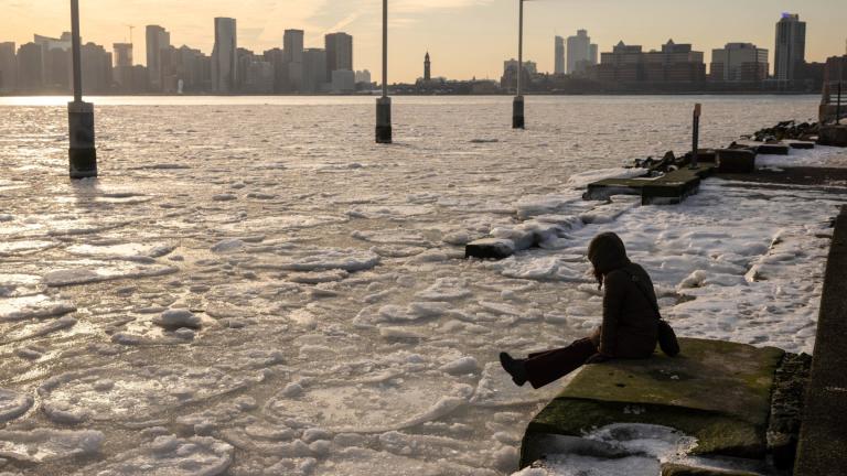 FILE - A person sits on the pier as ice floats on the Hudson River, Jan. 23, 2025, in New York. (AP Photo / Yuki Iwamura, File)