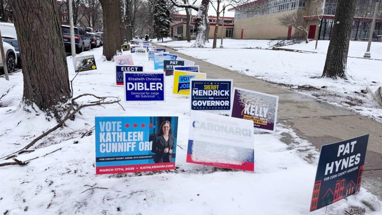 Candidate signs have been covered in snow and wind-blown at the 47th Ward's early vote site, March 16, 2026. (Patty Wetli / WTTW News)