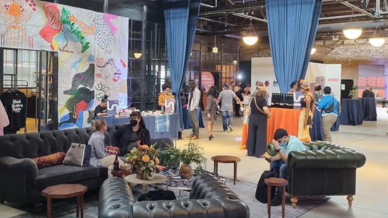 Attendees browse the Chicago Transformation Collab festival on June 25, 2022, which featured an array of local businesses, live art and panel discussions with community leaders. (Yahya Salem / WTTW News)
