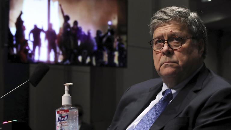 Attorney General William Barr listens during a House Judiciary Committee hearing on the oversight of the Department of Justice as a video plays in the background on Capitol Hill, Tuesday, July 28, 2020 in Washington. (Chip Somodevilla / Pool via AP)