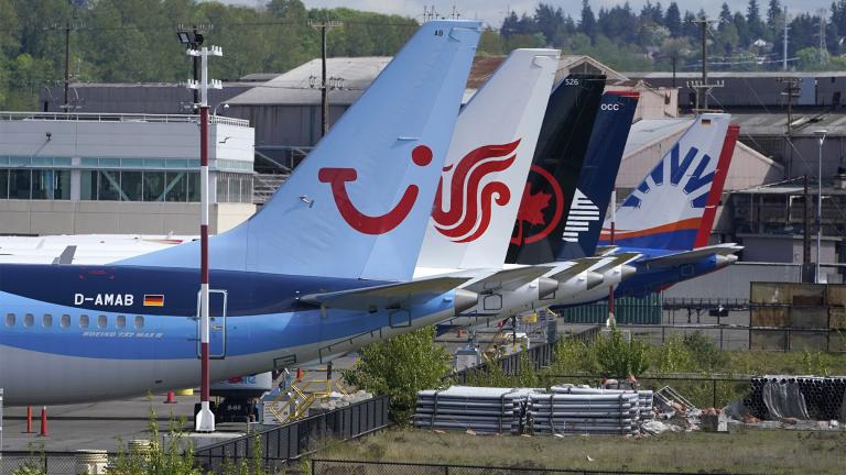 Boeing 737 Max airplanes, including one belonging to TUI Group, left, sit parked at a storage lot, Monday, April 26, 2021, near Boeing Field in Seattle. (AP Photo / Ted S. Warren)