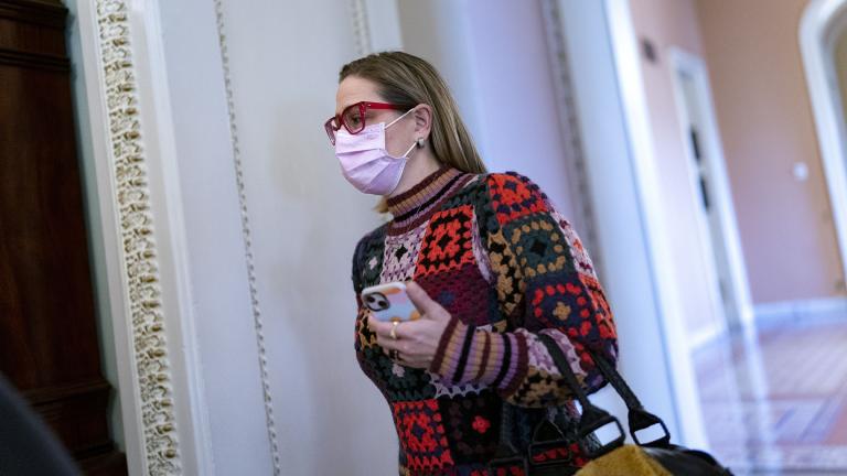 Sen. Kyrsten Sinema, D-Ariz., heads to a Democratic Caucus meeting as the Senate continues to grapple with end-of-year tasks at the Capitol in Washington, Thursday, Dec. 16, 2021. (AP Photo / J. Scott Applewhite)