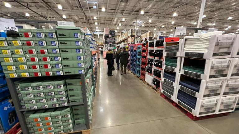 Shoppers make their ways down an aisle lined with clothing and shoes in a Costco warehouse Thursday, Jan. 23, 2025, in Sheridan, Colo. (AP Photo / David Zalubowski, File)
