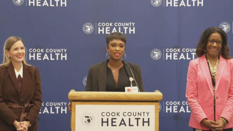 Shalonda Carter, center, a reproductive life planning coach at Cook County Health, speaks during a news conference on Tuesday, Dec. 3, 2024. (Courtesy of Cook County Government Livestream)