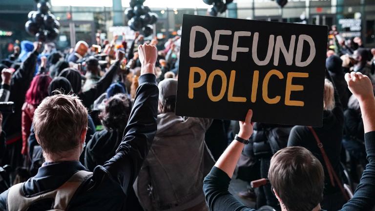 In this Oct. 14, 2020, file photo a protester holds a sign that reads "Defund Police" during a rally for the late George Floyd outside Barclays Center in New York. (AP Photo / John Minchillo, File) In this Oct. 14, 2020, file photo a protester holds a sign that reads "Defund Police" during a rally for the late George Floyd outside Barclays Center in New York. (AP Photo / John Minchillo, File)