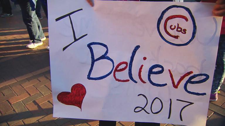 A Cubs fan shows off a sign before Game 3 at Wrigley Field. (Chicago Tonight)
