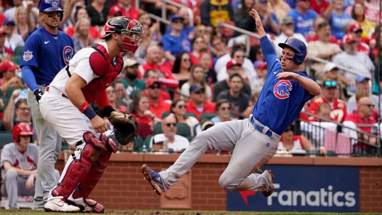 Chicago Cubs’ Frank Schwindel, right, scores past St. Louis Cardinals catcher Andrew Knizner during the fifth inning of a baseball game Sunday, Oct. 3, 2021, in St. Louis. (AP Photo / Jeff Roberson)