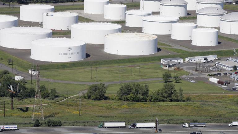 FILE - In this Sept. 8, 2008 file photo traffic on I-95 passes oil storage tanks owned by the Colonial Pipeline Company in Linden, N.J. (AP Photo / Mark Lennihan, File)