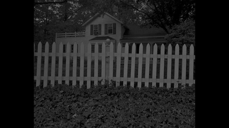 Dawoud Bey. “Untitled #1 (Picket Fence and Farmhouse),” from the series “Night Coming Tenderly, Black,” 2017. Rennie Collection, Vancouver. © Dawoud Bey.