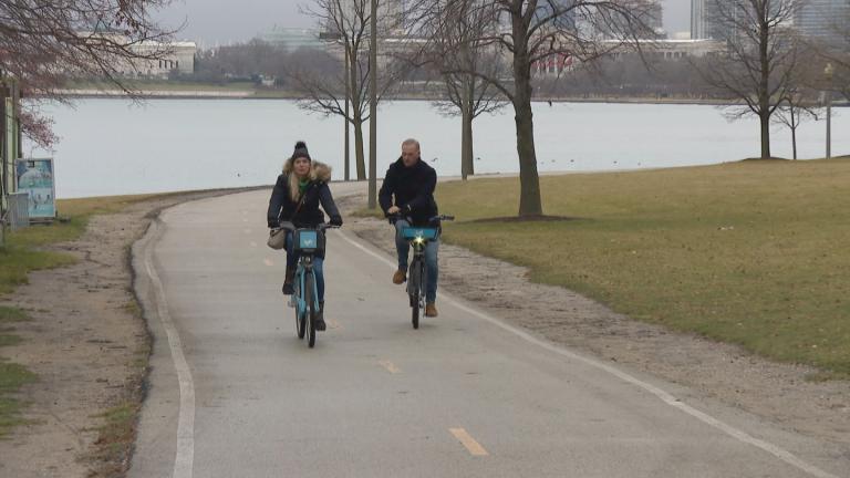 Two people ride bicycles in Chicago on Dec. 28, 2023. (WTTW News)
