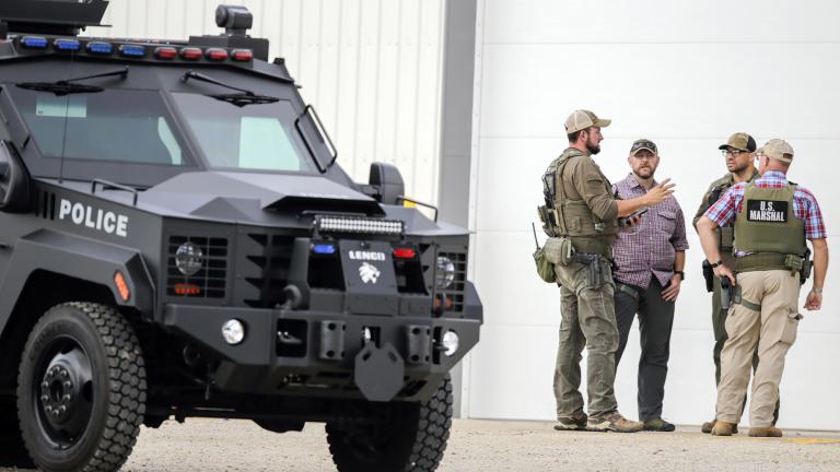 A tactical vehicle from the Cedar Rapids Police Department is seen as law enforcement stage as they search for a robbery and shooting suspect in Coggon, Iowa, on Monday, June 21, 2021. (Jim Slosiarek / The Gazette via AP)