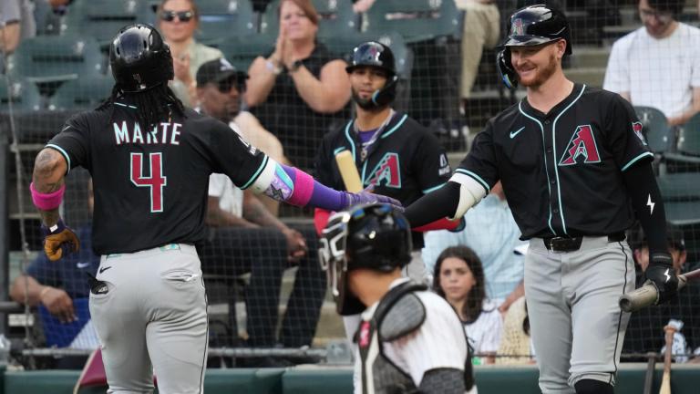Arizona Diamondbacks' Ketel Marte (4) celebrates with Pavin Smith after hitting a solo home run during the first inning of a baseball game against the Chicago White Sox in Chicago, Tuesday, June 24, 2025. (AP Photo / Nam Y. Huh)