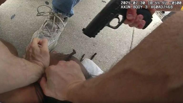 An image captured by a Chicago Police Department officer’s body-worn camera shows Officer Michael Donnelly pointing his gun at a man’s head while he is being restrained by other officers. (Civilian Office of Police Accountability)