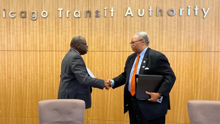 Outgoing CTA President Dorval Carter (right) shakes hands with CTA Board Chairman Lester Barclay at the Jan. 15, 2025, meeting of the transit agency’s board of directors. (Nick Blumberg / WTTW News)