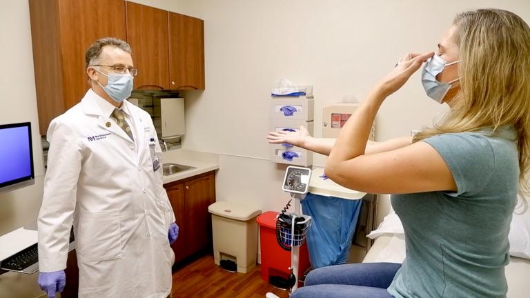 Dr. Igor Koralnik, left, examines a patient. (Credit: Northwestern Medicine)