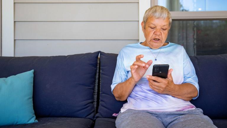 Sheri Wilkins talks about her experience using the DailyPay app outside of the clubhouse at her apartment complex in College Station, Texas on Tuesday, March 26, 2024. (Sam Craft / AP Photo)