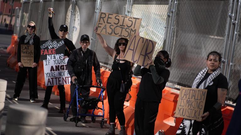 Protestors hold signs during a rally for a nationwide economic blackout Wednesday, Feb. 26, 2025, in Las Vegas. (AP Photo/John Locher)