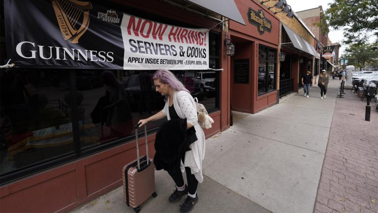 A traveller wheels her baggage past a now hiring sign outside a bar and restaurant Saturday, Oct. 9, 2021, in Sioux Falls, S.D. (AP Photo / David Zalubowski) A traveller wheels her baggage past a now hiring sign outside a bar and restaurant Saturday, Oct. 9, 2021, in Sioux Falls, S.D. (AP Photo / David Zalubowski)