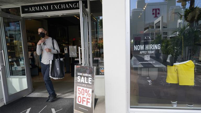 For sale and hiring signs are displayed at an Armani Exchange store, Friday, Jan. 21, 2022, in Miami Beach, Fla. (AP Photo / Marta Lavandier)