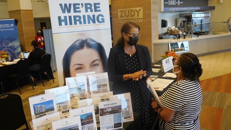 Marriott human resources recruiter Mariela Cuevas, left, talks to Lisbet Oliveros, during a job fair at Hard Rock Stadium, Friday, Sept. 3, 2021, in Miami Gardens, Fla. (AP Photo/Marta Lavandier, File)
