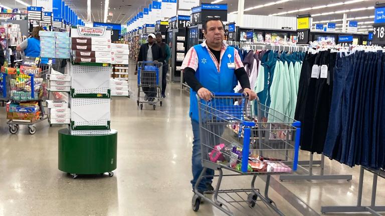 A employee pushes a cart at a Walmart in Vernon Hills, Ill., Tuesday, March 28, 2023. On Friday, the U.S. government issues the June jobs report. (AP Photo / Nam Y. Huh, File)