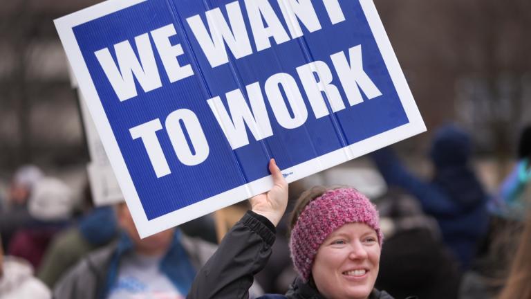 Katy Frank, a former computer scientist at the NOAA Great Lakes Environmental Research Lab, who lost her job Thursday, protests outside the John D. Dingell Veterans Affairs Medical Center in Detroit, Friday, Feb. 28, 2025. (AP Photo / Paul Sancya, File)